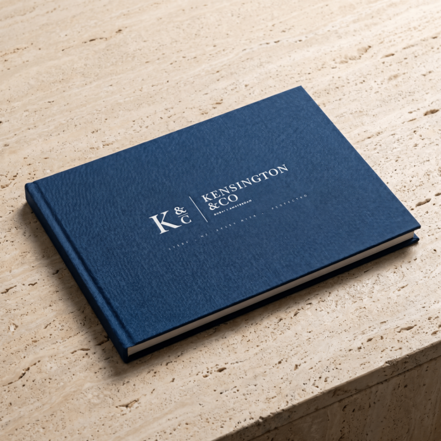 Kensington & Co. Company Profile — a navy linen hardcover monograph